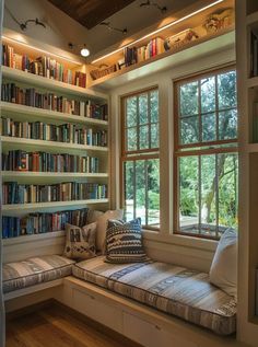 a window seat with bookshelves in front of it