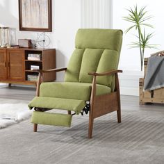 a green recliner chair sitting on top of a rug