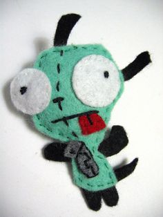 a green and black stuffed animal with big eyes