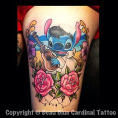 a tattoo with stitching on the thigh and flowers around it, including an image of stitch