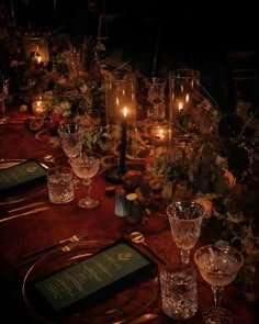 the table is set with candles and place settings for dinner guests to sit down at