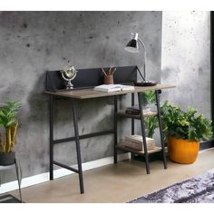 a desk with a lamp on it next to a plant