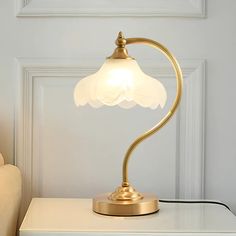 a lamp that is sitting on top of a white table in front of a door