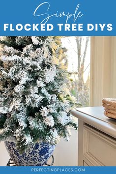 a blue and white vase filled with snowflakes on top of a counter next to a window