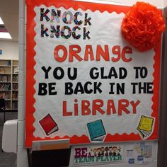 an orange sign that reads, knock knock orange you glad to be back in the library