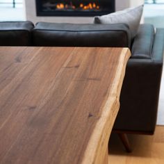 a couch and table in front of a fire place