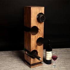 a wooden wine rack with two bottles of wine