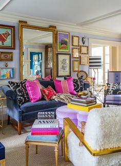 a living room filled with furniture and pictures on the wall