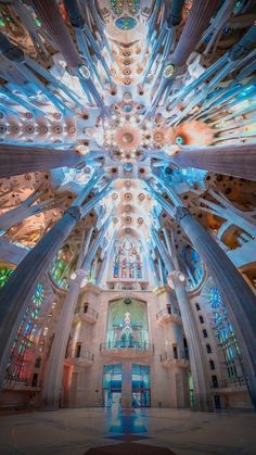 the inside of a large building with many windows and lights on it's ceiling