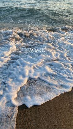 waves crashing on the beach with an ocean in the background