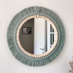 a round mirror hanging on the wall