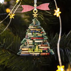 a christmas tree ornament with books on it