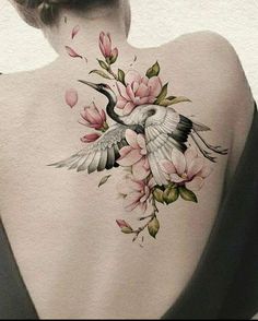 the back of a woman's body with flowers and birds painted on her back