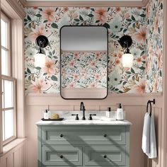 a bathroom with floral wallpaper and two sinks in front of a large mirror on the wall