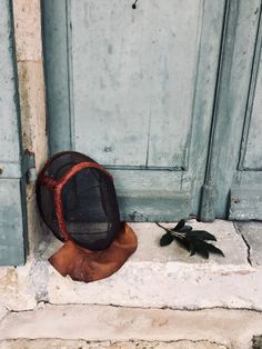 a hat sitting on the ground next to a door