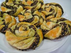 there are many different types of pastries on this white plate with black sprinkles