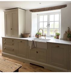 a kitchen with an oven, sink and window in the middle of it's room