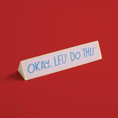 a sticker that says okay, let's do this on it against a red background