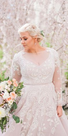 a woman in a wedding dress holding a bouquet