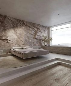 a bed sitting on top of a wooden floor next to a window in a bedroom