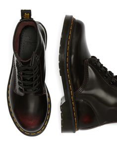 The iconic 1460 Dr. Martens boot features 8 eyes, grooved sides, a heel-loop, yellow stitching, and an air-cushioned sole. Made with Arcadia leather that develops a two-tone effect with wear, these boots also have our signature oil and fat resistant AirWair™ Bouncing Soles for traction and durability. To maintain the unique 2 tone look, simply clean with a damp cloth and use a Dr.Martens clear or colored wax polish. Available in true US sizes with room for comfort or thicker socks. UK sizes disp Rag Clothes, 1460 Dr Martens, Cherry Red Dr Martens, Red Dr Martens, Boots Uk, Leather Lace Up Boots, Doc Marten Oxford, Fashion 2024, Leather Lace