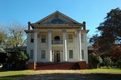 a large white house with columns and pillars