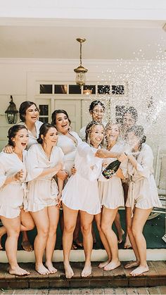 a group of women standing on top of a wooden floor in front of a door