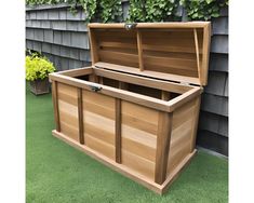 a large wooden box sitting in the grass