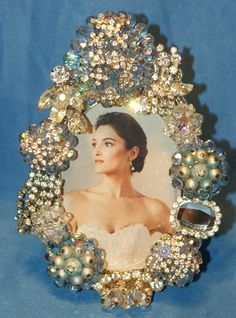 a woman's portrait is surrounded by jewels and pearls