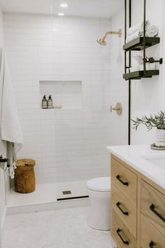 a bathroom with a toilet, sink and shower