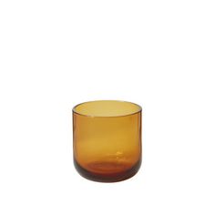 an orange glass cup sitting on top of a white table