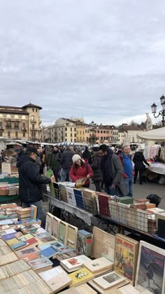 people browse at an outdoor flea market on a cloudy day in the old town