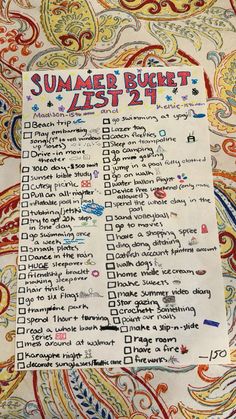 a summer bucket list is shown on top of a paisley print tablecloth with writing