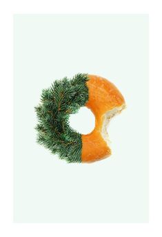 a merry christmas card with a donut and a wreath on it's side