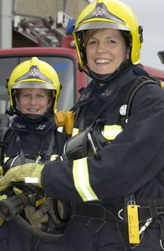 two fire fighters standing next to each other