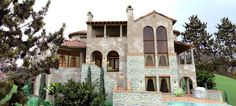 a large house with a pool in front of it