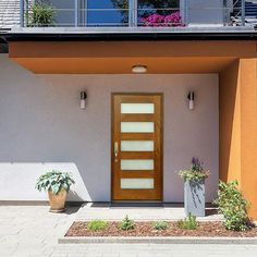 the front door of a house with two planters