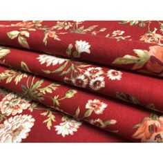 red floral fabric with white and orange flowers on the bottom, in different sizes and colors