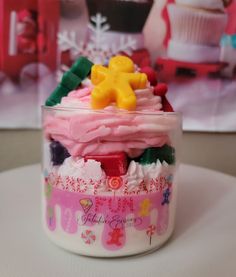 a small glass jar filled with frosting and candies