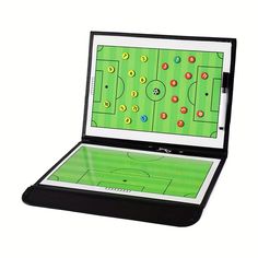 an electronic device with a soccer game on it's display case and its lid open