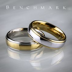 two gold and silver wedding rings sitting next to each other on a white surface with the words benchmark written below it