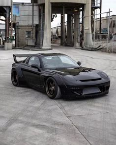 a black sports car parked in front of a building