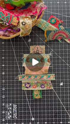 the video is showing how to make decorative fabric pieces with scissors and tape on a cutting board