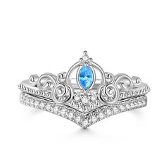 a tiara ring with blue topaz and white diamonds on the sides, set in 18k white gold