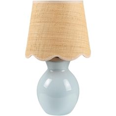 a light blue table lamp with a beige shade on the top and bottom part of it