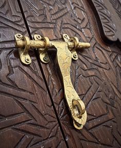 an ornate wooden door with brass handles