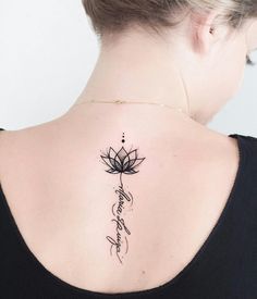 a woman with a lotus tattoo on her upper back neck and the word love written in cursive writing