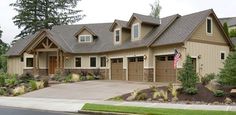 a large house with two garages and landscaping around it's front yard area