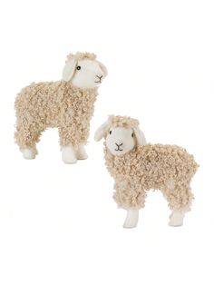 two stuffed sheep standing next to each other