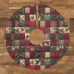 a quilted christmas ornament on a wood floor with the number eight in it